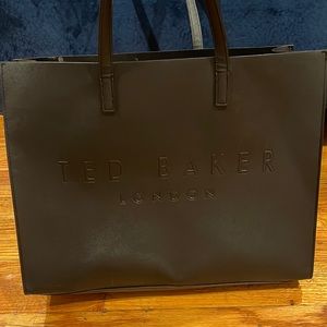 Ted Baker tote good on outside few spills that you can clean on the inside.